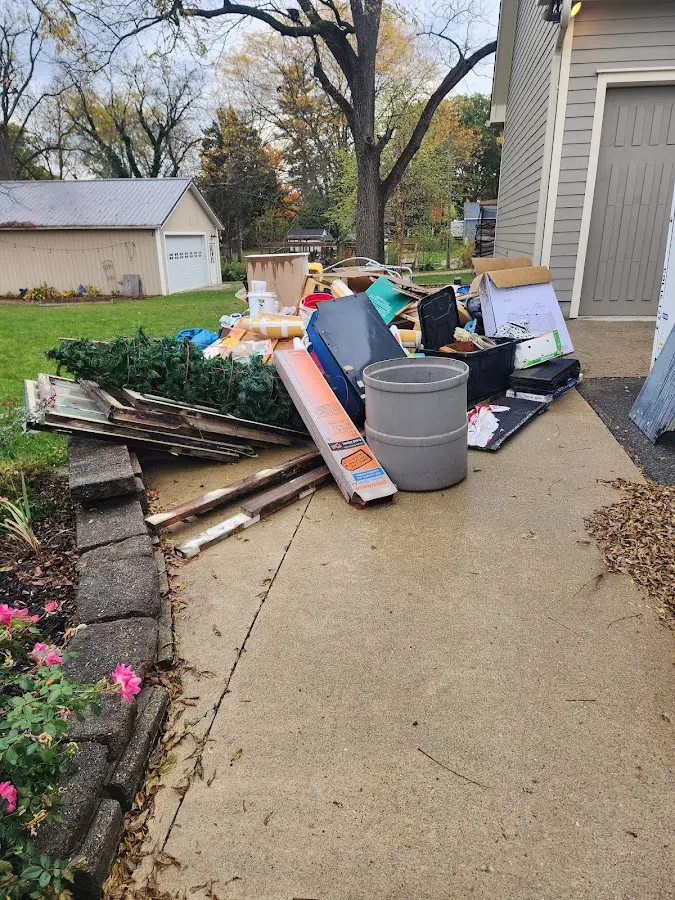 Dumpster being loaded with debris for Estate Cleanout Dumpster Rental in Woodmere